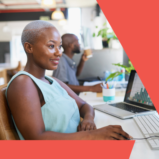 Smiling woman working at a desk with a data visualization of off-page SEO services on her laptop screen.