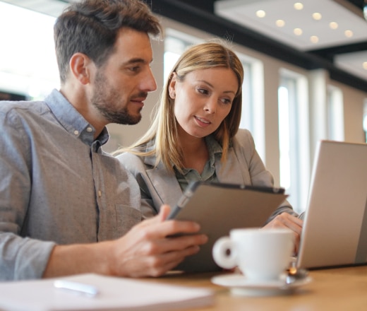 Two Austin SEO strategists review a client’s technical SEO in their brightly lit office.