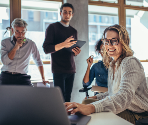 Four San Francisco SEO consultants gather in a bright office to discuss strategy for a Bay Area client.