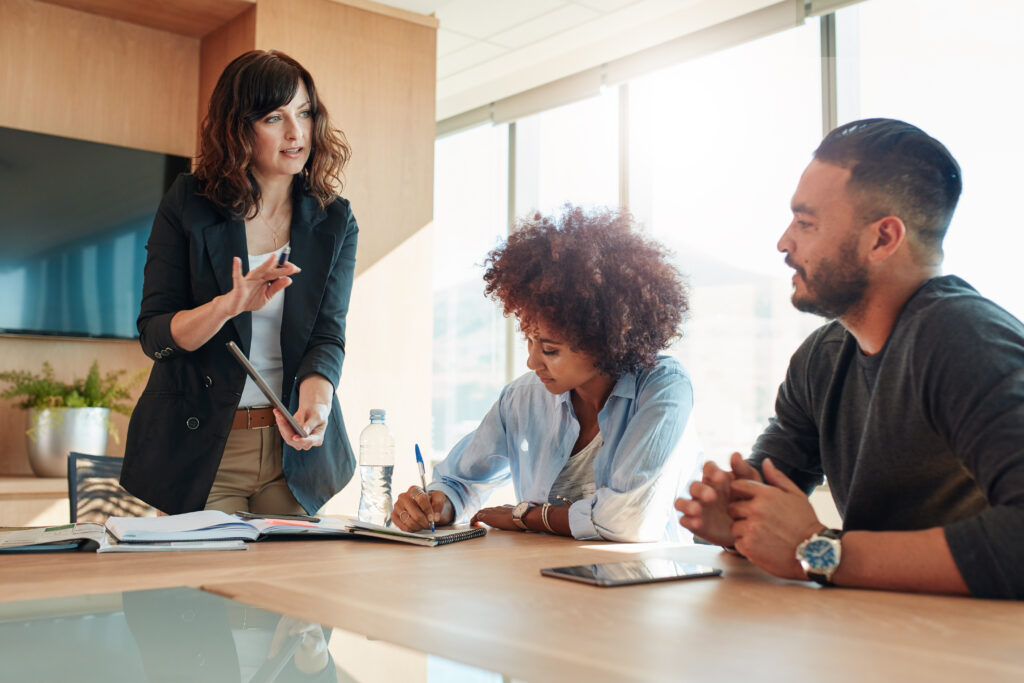 A group of people at a table discuss an SEO for professional services strategy.
