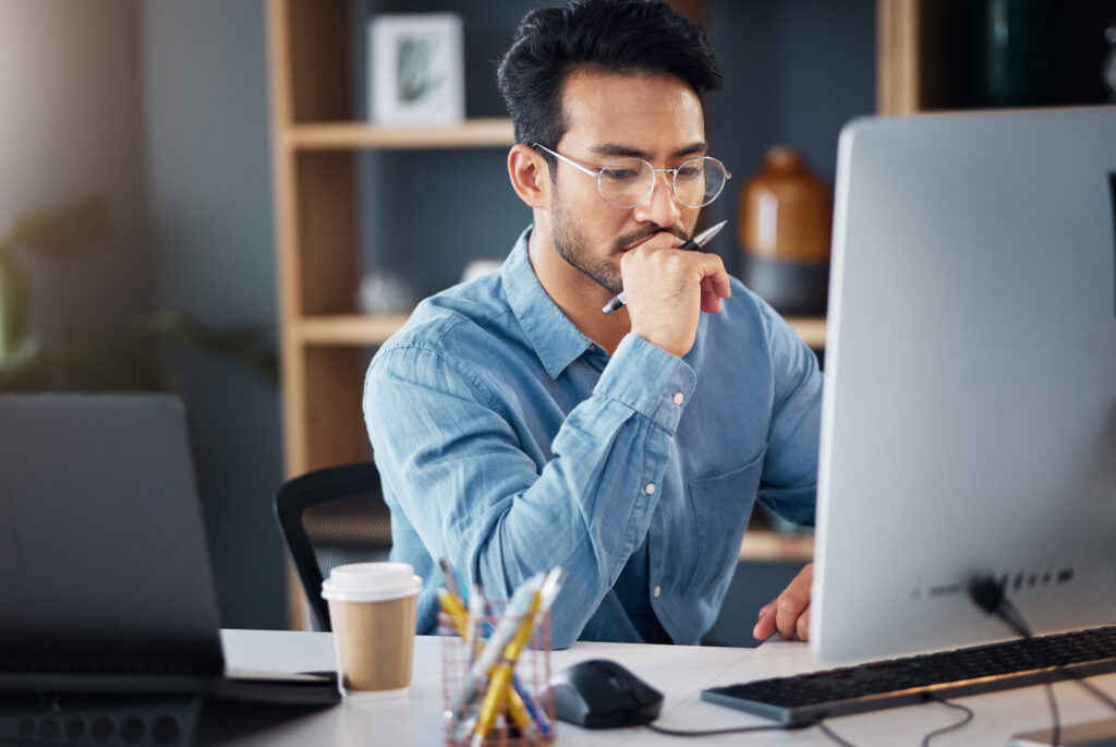 A man at a desk learning about the differences between technical SEO vs. content SEO.