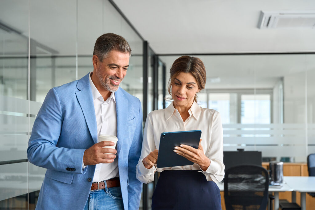 Two people in an office look at a report that shows the benefits of enterprise SEO.