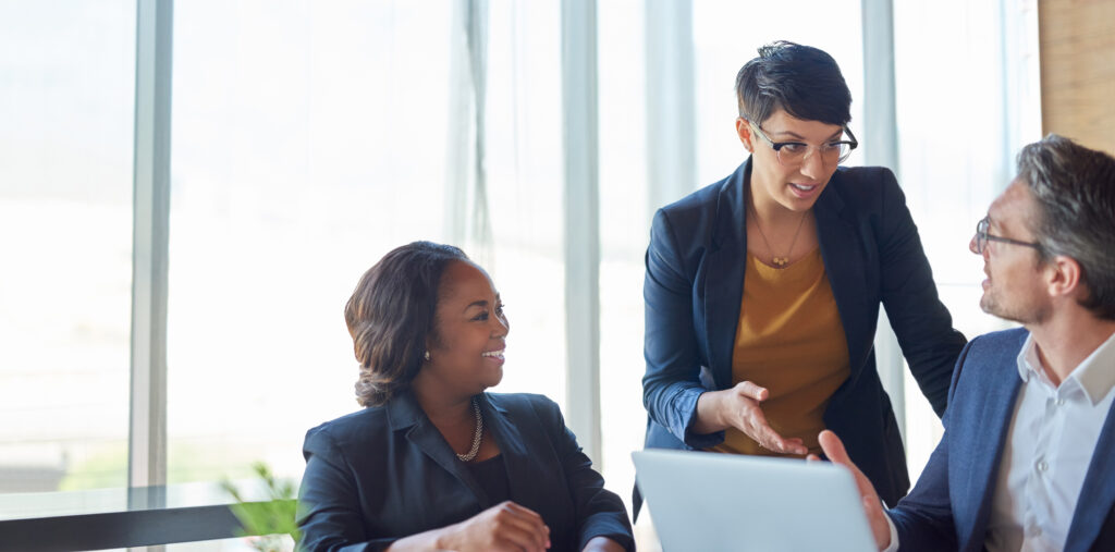 A group of office workers discusses enterprise technical SEO.